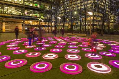 In the early 1990s, London’s Canary Wharf struggled because of a dearth of retail, leisure, and cultural spaces, as well as a lack of rail connectivity to the central city. After a financial rescue, developers diversified the development mix to include more than 60 bars, cafés, and restaurants. Public art, such as this installation of interactive circular pads by Jen Lewin for a winter lights festival at Canary Wharf, adds to the sense of vibrancy. (©RubinowaDama/Shutterstock.com)