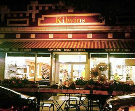 Kilwins chocolate, fudge, and ice cream shop was an early arrival on the revitalized 53rd Street Corridor in Chicago’s Hyde Park neighborhood.  The building had been renovated with metal panels, completely covering the original red brick and terra-cotta detailing.