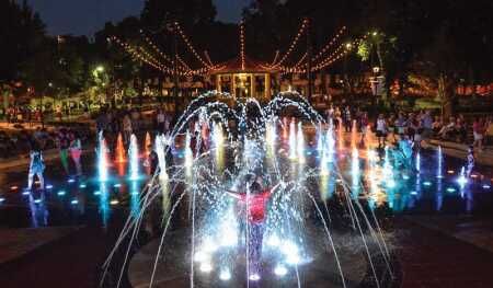 The water feature at Cincinnati’s Washington Park dances to lights and music at night. (J. MILES WOLF)