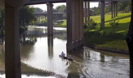 For decades, Buffalo Bayou Park—adjacent to downtown but hidden by bridges and freeway overpasses—was neglected and overgrown. Now that it is being reclaimed, even canoeists are returning to the slow-moving bayou waters. (Buffalo Bayou Partnership/Tom Fox/SWA Group)