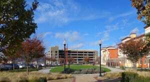 The village’s green infrastructure includes Charlotte Commons (right) and three miles (5 km) of walkable streetscapes, a five-mile (8 km) multiuse path, and greenways, parks, and sports fields; on the right are the village’s first developed homes. Starbucks (below) is a draw at the Village Oaks retail center, anchored by Target and Safeway. (Ken Kay Associates)