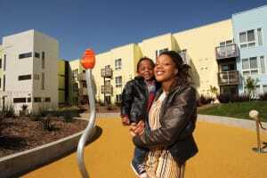 New residents Jasmin Hudson and her son enjoy the playground at Bridge Housing’s Ironhorse at Central Station, a 99-unit affordable housing complex in West Oakland. (Julio Cesar Martinez)