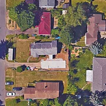 Teague Douglas, a 30-year-old green building and energy efficiency professional, found a 6,450-square-foot (600 sq m) lot (center left) in Portland with a 950-square-foot (88 sq m) one-story bungalow and a 320-square-foot (30 sq m) shop. She bought it in 2012 for $162,900 with a plan to rent it out for about $1,400 per month while building a PAD of 550 square feet (51 sq m) with loft in which to live herself. (Google Earth)