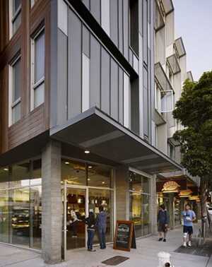 The corner bakery at Richardson Apartments—housing formerly homeless individuals in San Francisco’s trendy Hayes Valley—provides a popular amenity for the neighborhood and runs a program training residents in job skills. (©david baker architects)