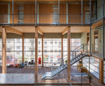 The interior shared space at La Borda, a cohousing project in Barcelona, Spain, is defined by an open atrium.