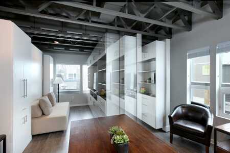 Urbaneer’s space-optimizing product line includes a movable wall, which slides at the push of a button along ceiling-mounted rollers and features an entertainment center on one side and a built-in workstation desk on the other. (Urbaneer/Michael Buck)