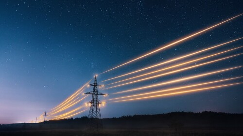 Electricity,Transmission,Towers,With,Orange,Glowing,Wires,The,Starry,Night