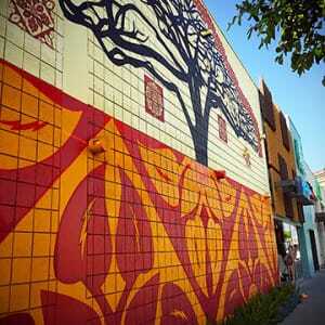 Madison Marquette’s tenant mix combines nostalgia and trendy men’s fashions. Far right: The developer allowed urban artist Shepard Fairey carte blanche to decorate a key building on the avenue. (Sean Slater)