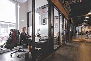 Coworking spaces typically offer a range of options, from desk space in a bullpen area to enclosed spaces for small-business people who want a quieter atmosphere. (Photo Courtesy of WeWork)