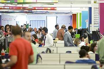 Mortgage bankers sell loans to customers at Quicken Loans’ operations center in the Qube.