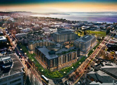 A rendering of Kirkland Urban at buildout. The site overlooks the 7.5-acre (3 ha) Peter Kirk Park and is close to City Hall in the original town center. Seattle is across Lake Washington in the distance. (CollinsWoerman)