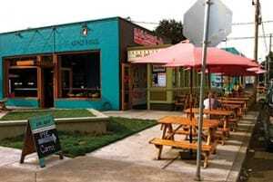 Streetside umbrella tables expand seating for the micro-restaurants and attract business. (William P. Macht)