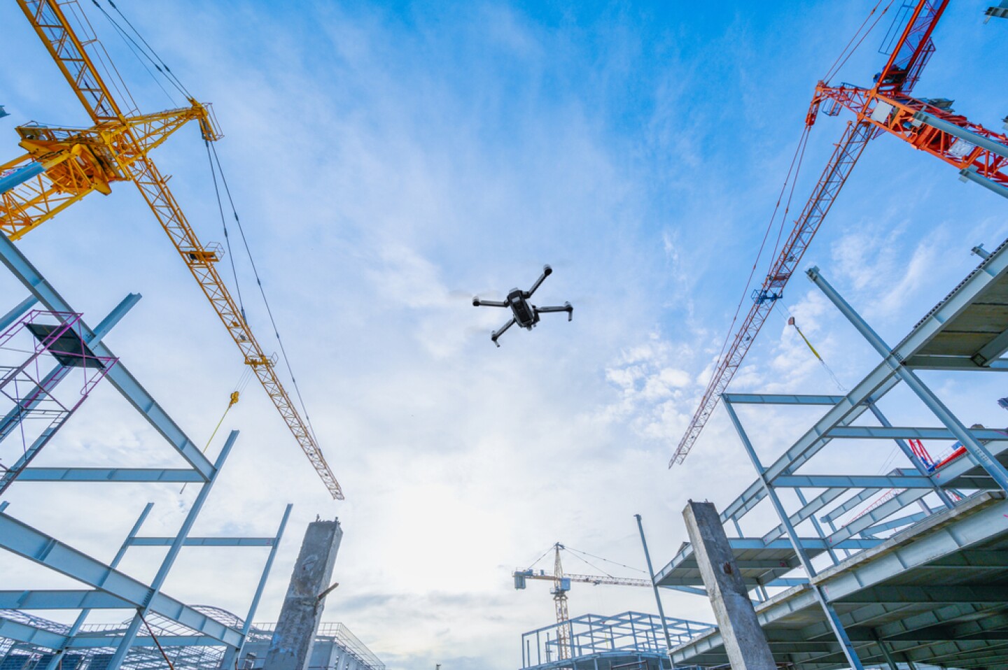 Drone,Over,Construction,Site.,Video,Surveillance,Or,Industrial,Inspection A drone hovers over a construction site.
