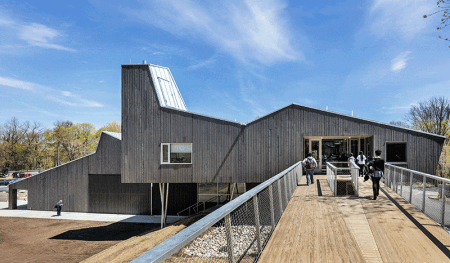 An 80-foot-long glue-laminated timber bridge marks the main entry to a new 14,000 square-foot addition to Common Ground High School, one of the first cross-laminated timber (CLT) buildings in the United States. (Photo: David Sundberg; ESTO/Courtesy: Gray Organschi Architecture)