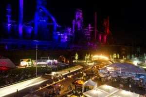 The Levitt Pavilion SteelStacks campus with the flame from The Bridge by Elena Colombo adding to the colorful illumination. (Photo by Jeff Levy)