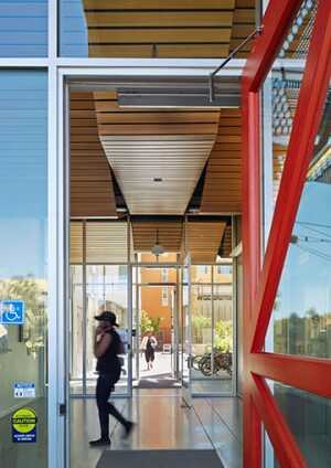 Transparency and views into interior green space can take the place of entry courtyards in a tight site. An entry courtyard serves as a decompression zone, buffering housing from the busy street. (©bruce damonte)