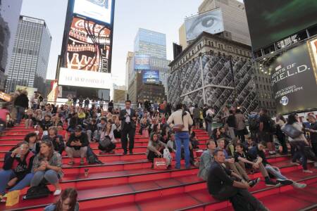 Bleacher-style seating gives pedestrians a place where they can pause and take in the spectacle of Times Square. (EarthScape ImageGraphy/Shutterstock.com)