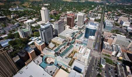 This view looking east shows the large-scaled street grid of the city; the Mormon Tabernacle can be seen at left and the state Capitol at far upper left. The blue-glazed Regent condominium tower rises at the right center of the project. (William Tatham, SWA Group)